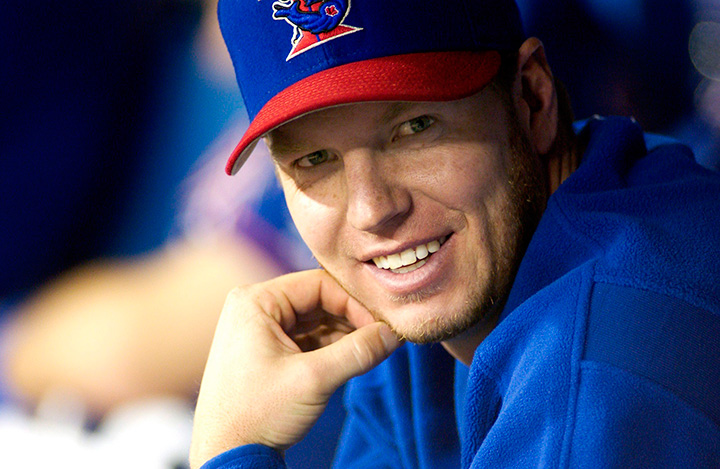 Former Toronto Blue Jays pitcher Roy Halladay smiles on the bench in Toronto in 2003. 