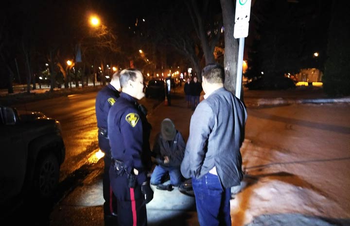Rob Clarke with Saskatoon police officers at the scene of the arrest on Spadina Crescent.
