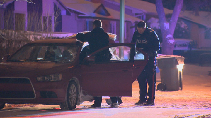Saskatoon police search a car believed to have been used as the getaway vehicle in two armed robberies on Nov. 10, 2017.