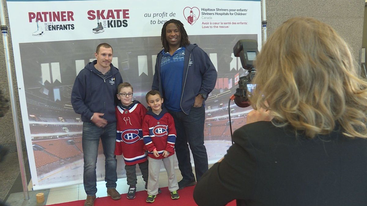 Canadiens Brendan Gallagher, left, and former team forward Georges Laraque pose for photos with kids at a Skate for Kids event in Montreal, Sunday November 12, 2017.  The event was a fundraiser for the Shriners Hospital for Children.  (Global News).