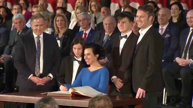 Valérie Plante, Montreal’s first female mayor, signs the livre d'or at her inauguration, Thursday, Nov. 16, 2017.