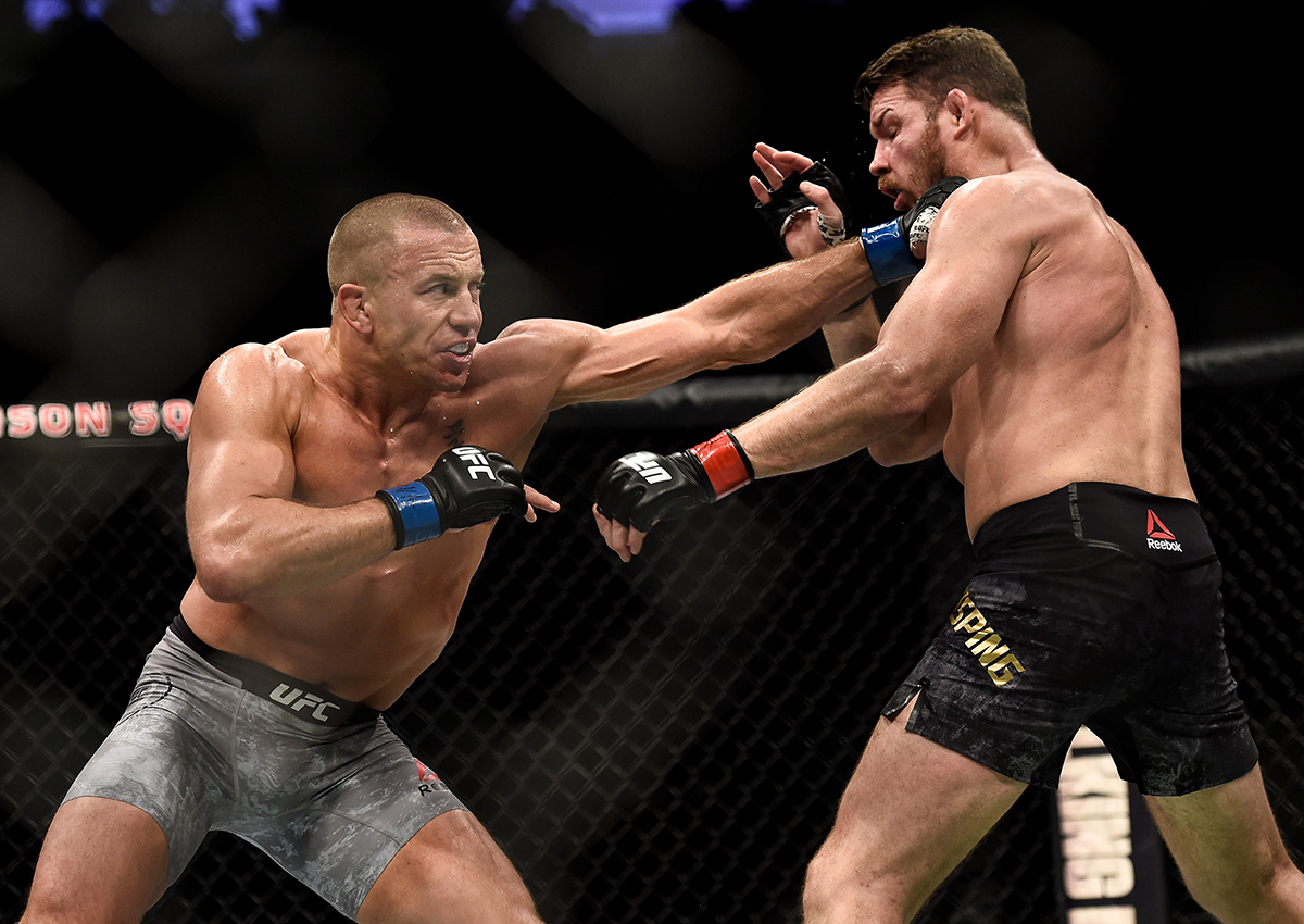 Georges St-Pierre of Canada punches Michael Bisping of England in their UFC middleweight championship bout during the UFC 217 event inside Madison Square Garden on November 4, 2017 in New York City.
