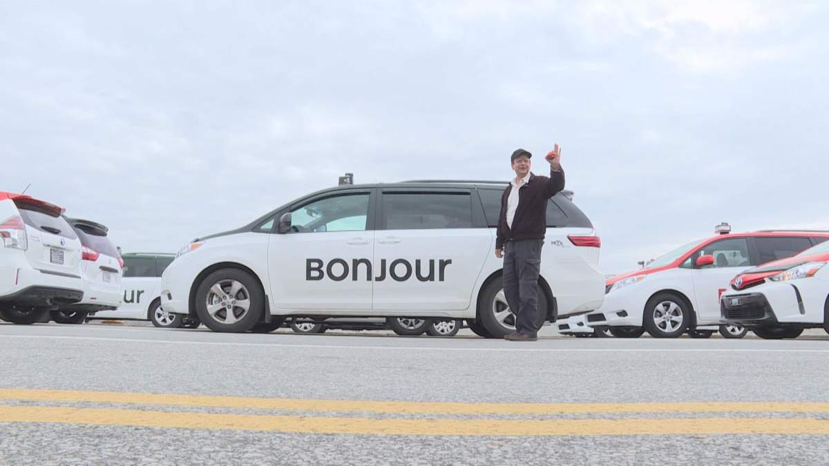 A Montreal taxi driver with his car painted with a new logo, at the Pierre Elliot Trudeau airport in Montreal, Wednesday November 1, 2017.  