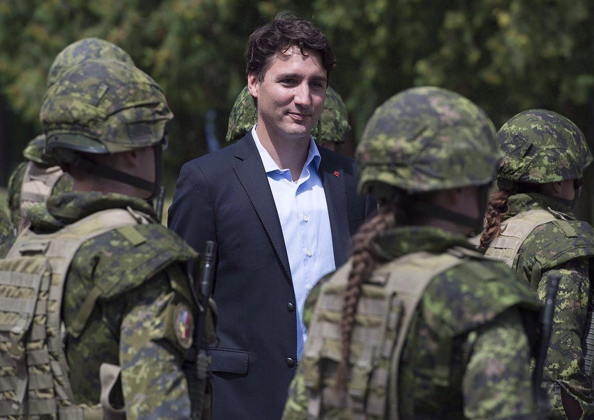 Canadian Prime Minister Justin Trudeau reviews an honour guard as they arrive at the International Peacekeeping and Security Centre in Yavoriv, Ukraine Tuesday July 12, 2016. 