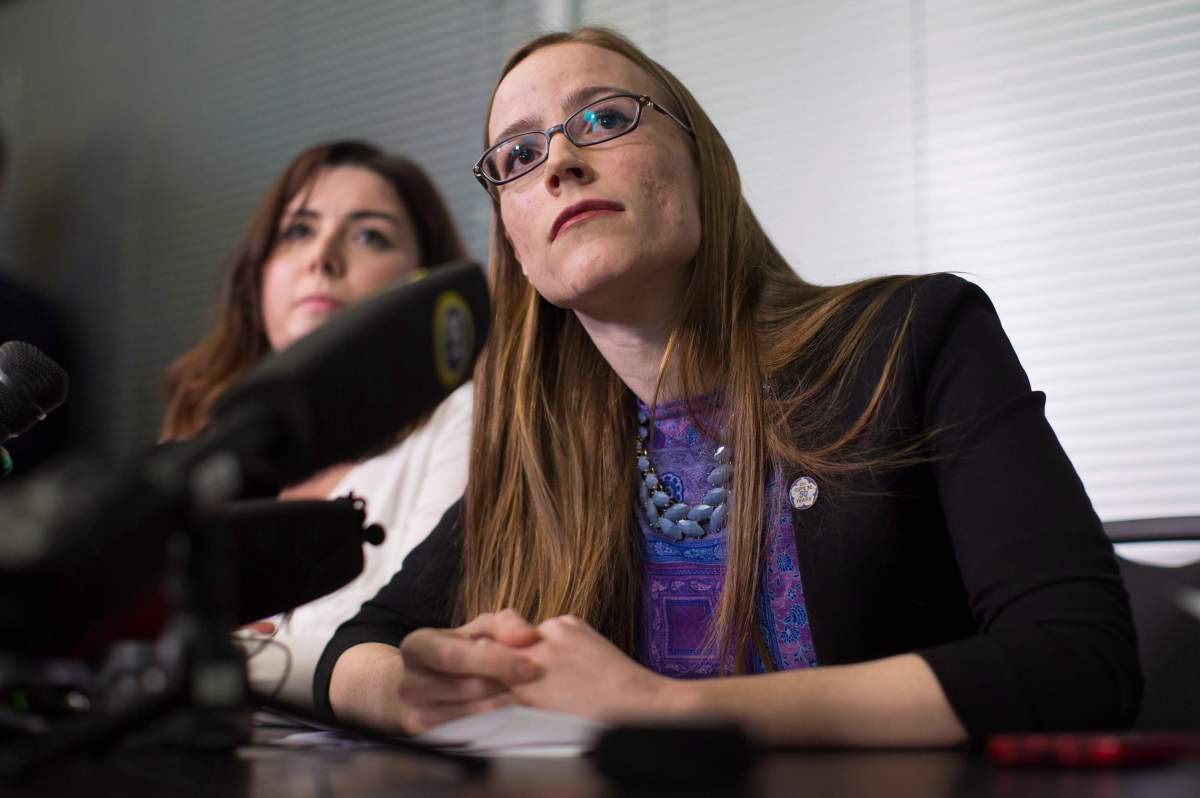 Former University of British Columbia students Glynnis Kirchmeier and Caitlin Cunningham, back, listen during a news conference at the university in Vancouver, B.C., on Sunday, November 22, 2015.