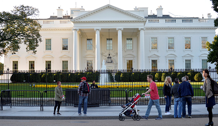 Tourists and pedestrians visit outside the White House in Washington, October 28, 2017. 