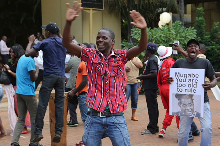 Zimbabweans celebrate in Harare, Tuesday, Nov, 21, 2017, after the resignation of President Robert Mugabe.