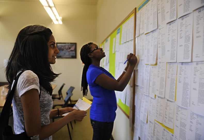 Zohra Surani, 21, left and Melinda Cuffy, 23, pour over job listings at the Summer Jobs Services Centre at 511 Richmond Street West in downtown Toronto.  
