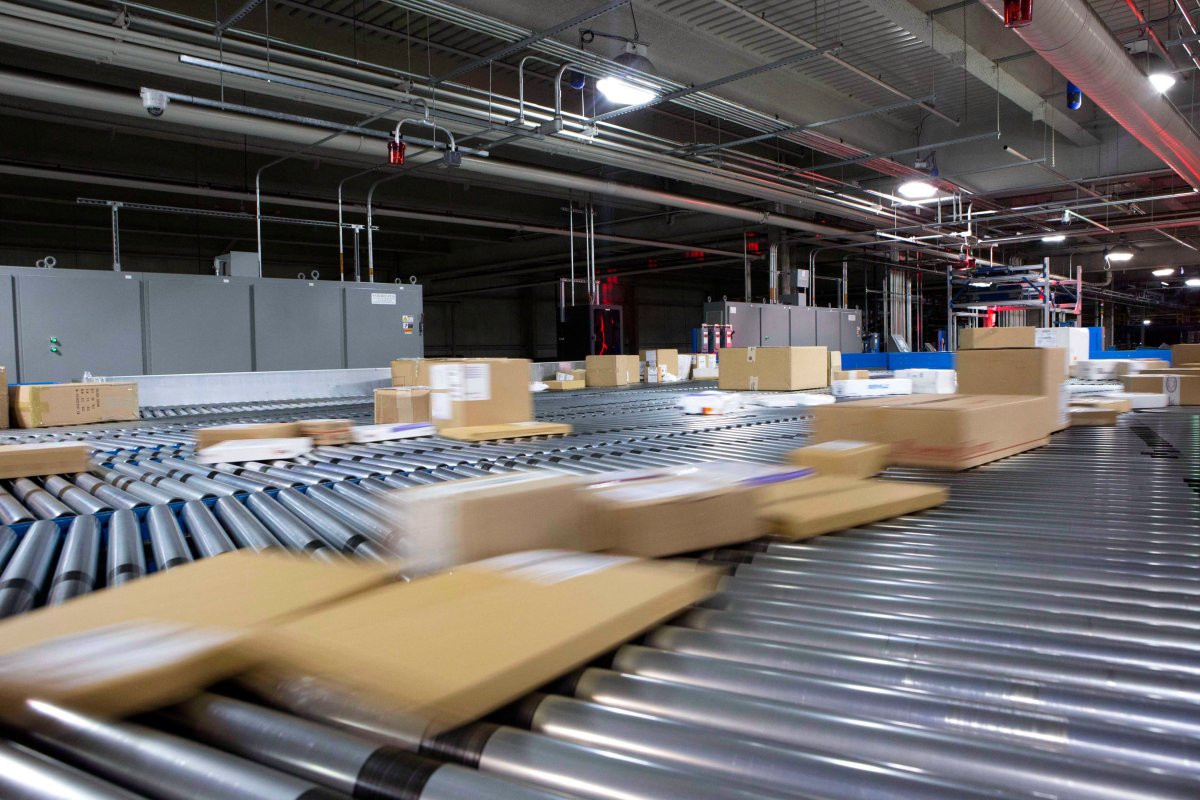 Packages move on a conveyor to be sorted at a mail facility.