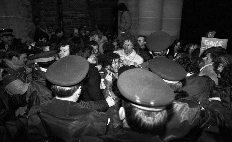 A man with blood streaming down his face scuffles with police outside the Ontario Legislature in Toronto on Feb. 6, 1981 after demonstrators marched there in protest of the arrests on Feb. 5, 1981 of 253 men in four city steam baths.