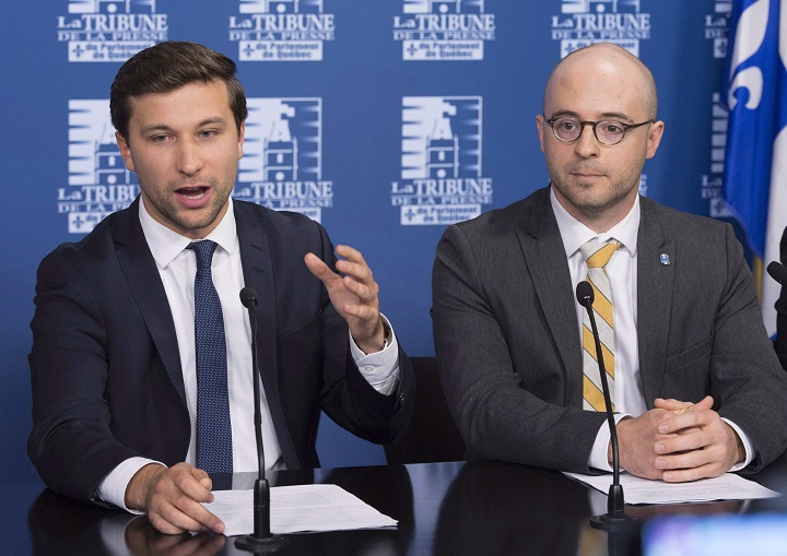 In this Oct. 2017 file photo, Quebec Solidaire MNA Gabriel Nadeau-Dubois, left, speaks at a news conference in Quebec City while Option nationale leader Sol Zanetti, right, looks on. The parties announced their intention to merge, but the deal must be endorsed by both memberships before it becomes official.