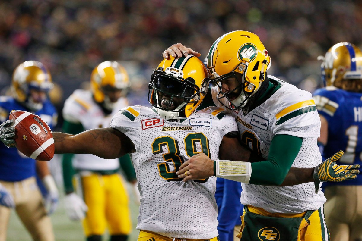 Edmonton Eskimos' C.J. Gable (39) and quarterback Mike Reilly (13) celebrate Gable's winning touchdown against the Winnipeg Blue Bombers during the second half of CFL western semifinal action in Winnipeg on Sunday, November 12, 2017. 