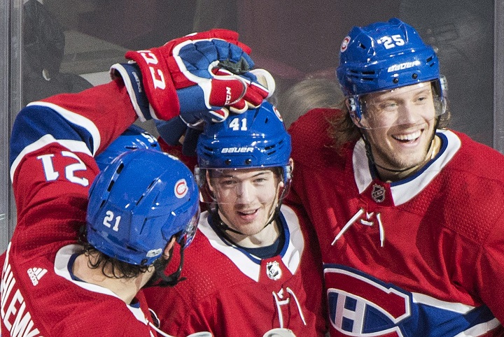 Montreal Canadiens' Paul Byron, centre, celebrates with teammates David Schlemko, left, and Jacob de la Rose after scoring against the Detroit Red Wings during second period NHL hockey action in Montreal, Saturday, December 2, 2017. 