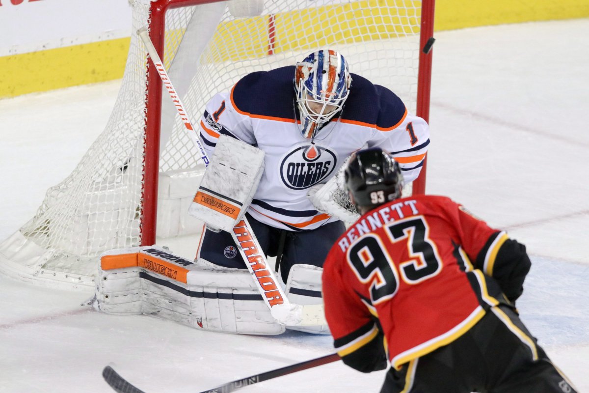 Calgary Flames' Sam Bennett scores on Edmonton Oilers goalie Laurent Brossoit during third period NHL hockey action in Calgary, Saturday, Dec. 2, 2017.