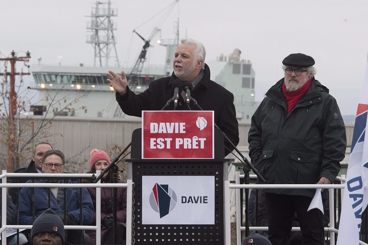 CSN union leader Yves Fortin, right, looks on as Quebec Premier Philippe Couillard, left, speaks with the hundreds of people at the end of a march of solidarity for the Davie Shipyard, in Levis, Que., on Sunday, Dec. 3, 2017. 