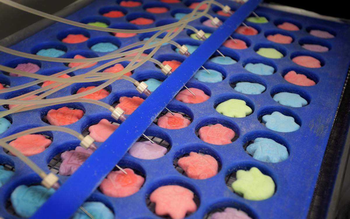 Drops of marijuana extract are placed on candy in the kitchen of AmeriCanna Edibles on Tuesday, April 25, 2017 in Boulder, Colo.