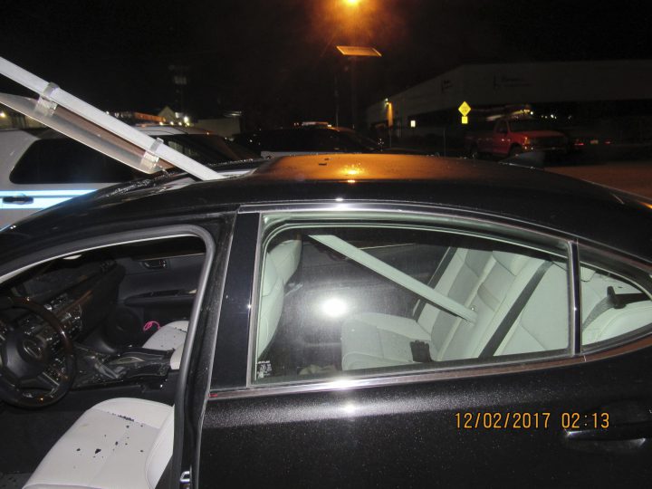 A photo provided by the South Hackensack Police Department shows a car with a mass transit sign sticking out of the roof. 