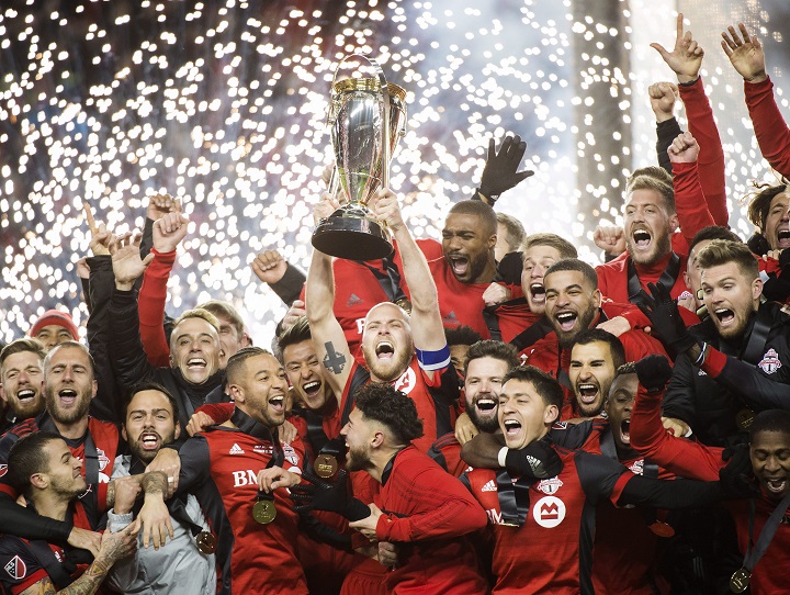 Toronto FC midfielder Michael Bradley, centre, hoists the MLS Cup with teammates after defeating the Seattle Sounders during MLS Cup soccer action in Toronto on Saturday, December 9, 2017. T.