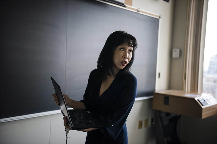 Mary Reid, professor of math education at the University of Toronto's Ontario Institute for Studies in Education, writes a math problem on a chalkboard at OISE in Toronto on Friday, December 8, 2017. 