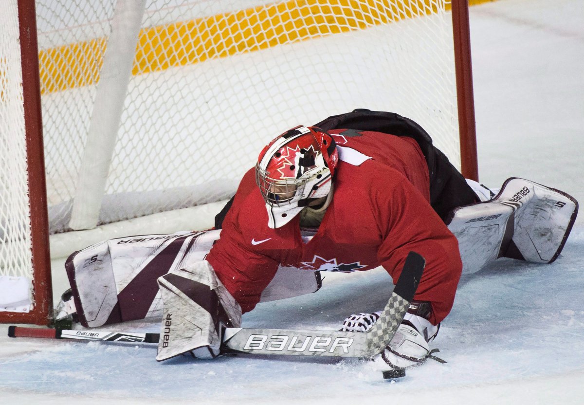 Canada goalie Colton Point (1) makes a huge save on while playing against USports' during second period exhibition hockey action in preparation for the upcoming IIHF World Junior Championships in St. Catharines, Ont., on Thursday, December 14, 2017. THE CANADIAN PRESS/Nathan Denette.