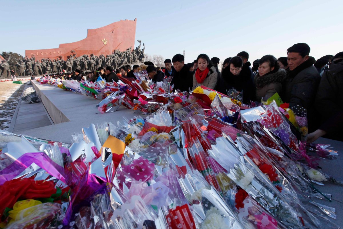 People lay flowers in front of the bronze statues of their late leaders Kim Il Sung and Kim Jong Il at Mansu Hill, marking the sixth anniversary of leader Kim Jong Il's death in Pyongyang, Sunday, Dec. 17, 2017. 