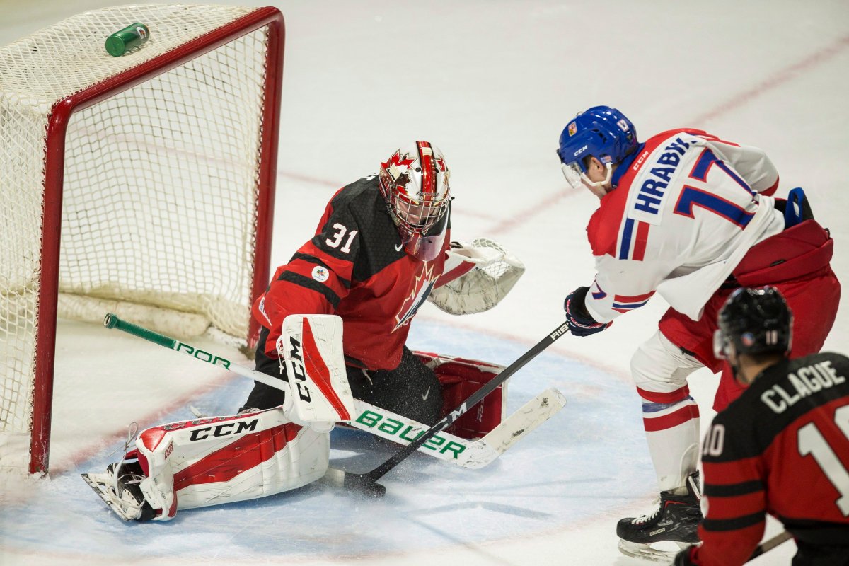 The Czech Republic's Krystof Hrabik tries to put the puck past Canada's goalie Carter Hart during the third period in their World Junior Championships pre-tournament game in London Ont. on Wednesday, December 20, 2017. 