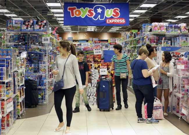 In this Nov. 25, 2016, file photo, shoppers browse at a Toys R Us store in Miami. 