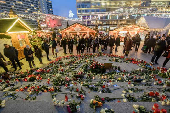 Visitors stand next to the memorial for the terror attack of 19 December 2016 on the  Christmas market at Breitscheidplatz in Berlin, Germany, 22 December 2017. 

