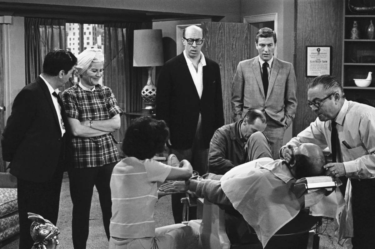 In this April 11, 1963 file photo, from left, Morey Amsterdam, Rose Marie, and Richard Deacon, and Dick Van Dyke gather around Carl Reiner (in barber chair) during a rehearsal for the “The Dick Van Dyke Show.”
