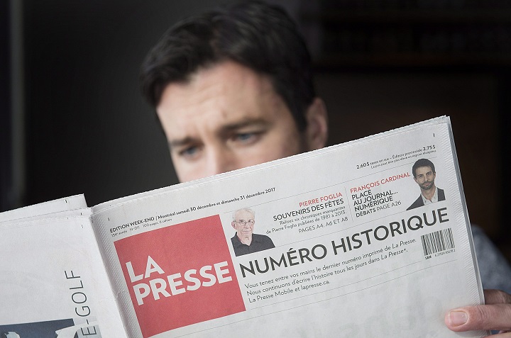 A man reads the final print edition of the French language newspaper La Presse at a coffee shop in Vaudreuil-Dorion, west of Montreal, Saturday, December 30, 2017. 