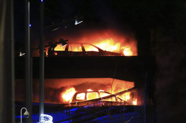 Vehicles burn during a blaze at a multi-storey car park at the Echo Arena on the waterfront in Liverpool, England, Sunday, Dec. 31, 2017.