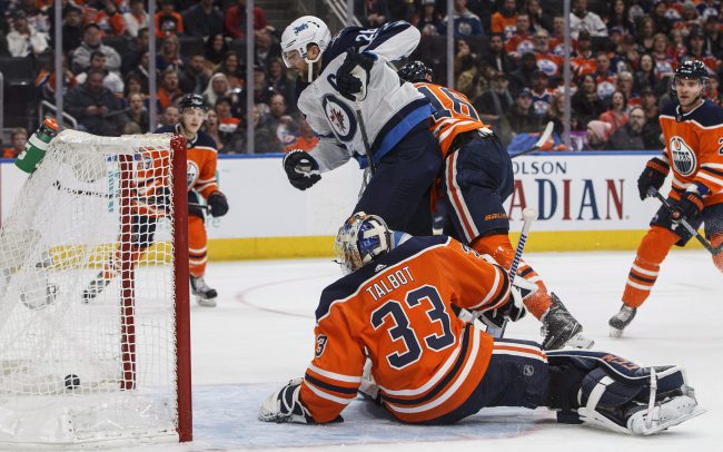 Winnipeg Jets' Blake Wheeler (26) watches the puck cross the line as Edmonton Oilers goalie Cam Talbot (33) tries to make the save during first period NHL action in Edmonton on Sunday, Dec. 31, 2017.