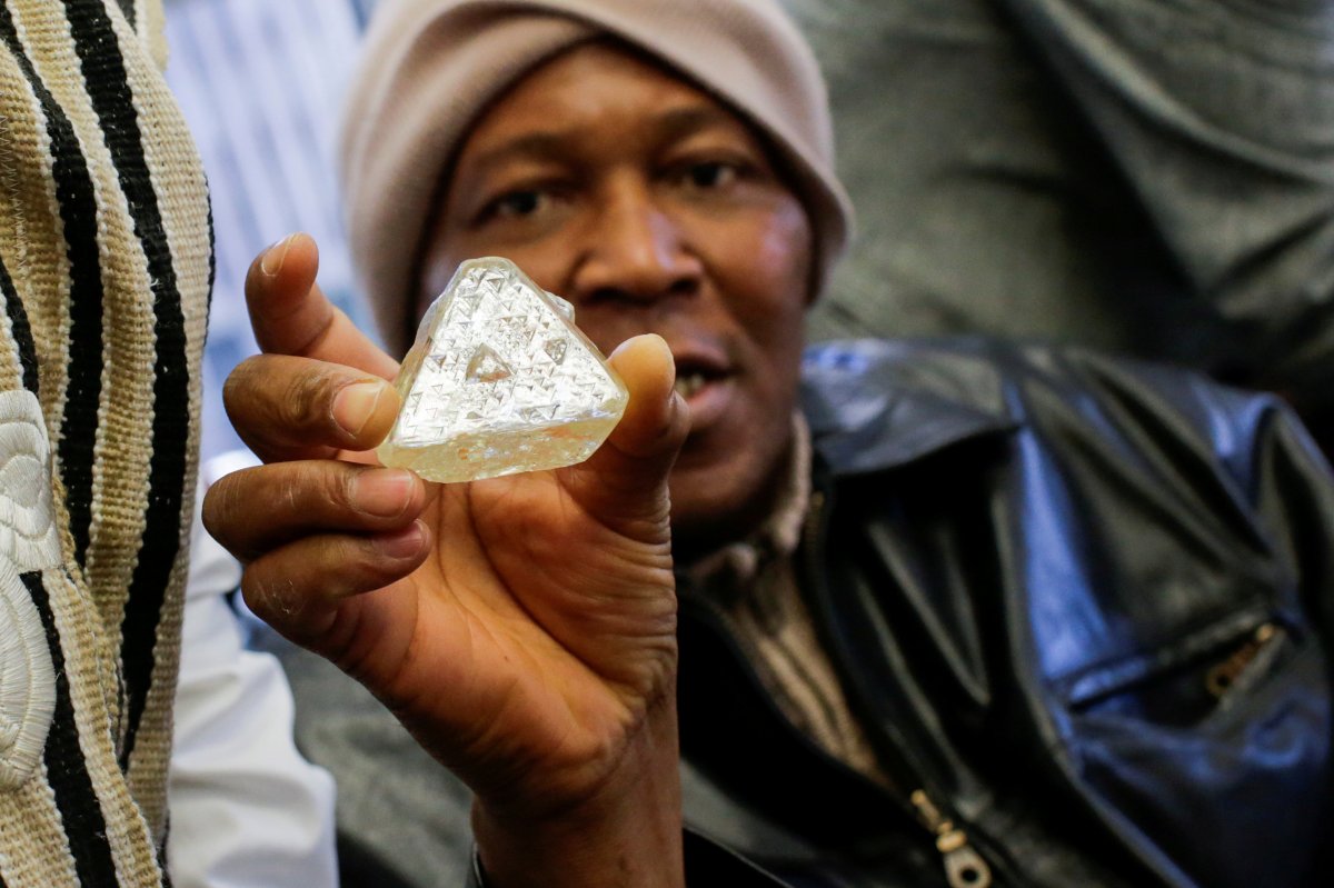 Dennis Kabatto, from Sierra Leone, holds the 709-carat diamond as it is presented during a news conference before auction in New York, U.S., November 21, 2017. 