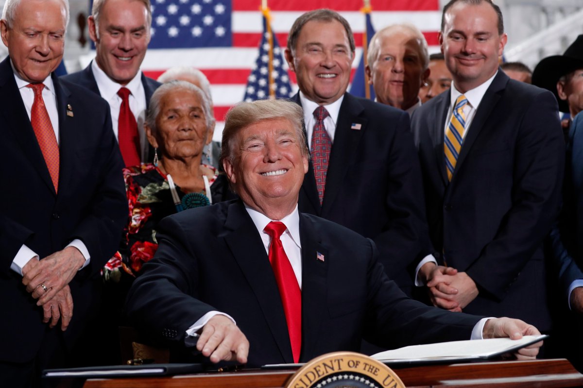 Donald Trump smiles upon signing an executive order after announcing big cuts to Utah's sprawling wilderness national monuments at the Utah State Capitol in Salt Lake City, Utah, U.S., December 4, 2017.