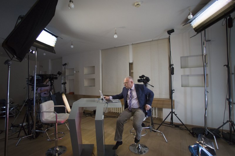 In this Wednesday, Dec. 10, 2014 photo, Dozhd Channel anchor Pavel Lobkov, prepares for a broadcast in their studio-apartment in Moscow, Russia. In December 2015, Lobkov was getting ready for his show when jarring news flashed across his phone: Some of his most intimate messages had just been published to the web. 