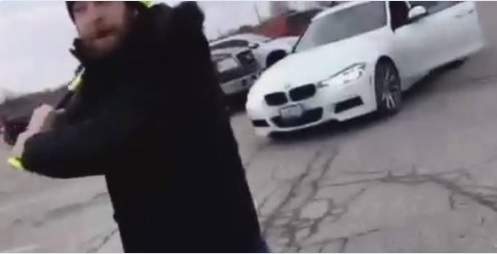 Mark Phillips is seen in a video swinging a baseball bat in a St. Thomas shopping mall parking lot.