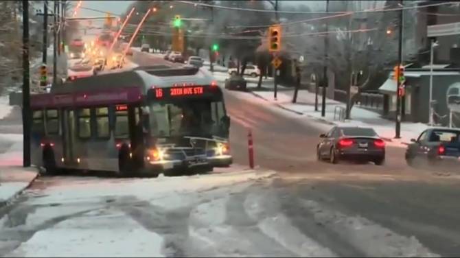 File photo. A TransLink bus struggles to get purchase in Vancouver snow. 