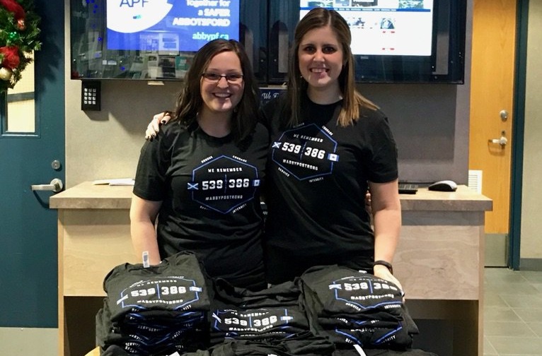 Staff at the Abbotsford Police Department selling John Davidson T-shirts.