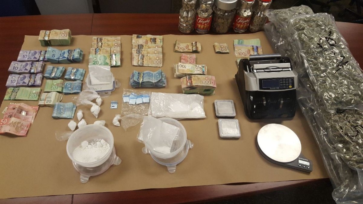 London police say their officers seized more than $140,000 in drugs and cash during a raid on Thursday.