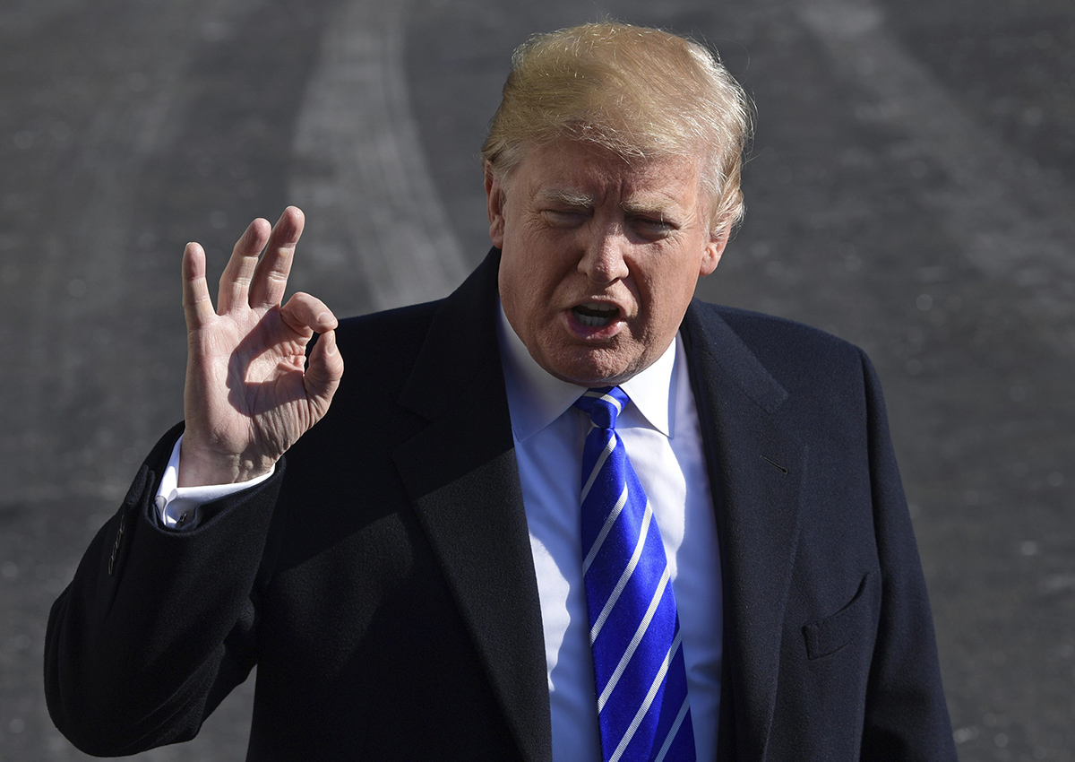 President Donald Trump talks with reporters as he departs from the South Lawn of the White House via Marine One in Washington, Saturday, Dec. 16, 2017, to spend the weekend at Camp David in Maryland. (AP Photo/Susan Walsh).