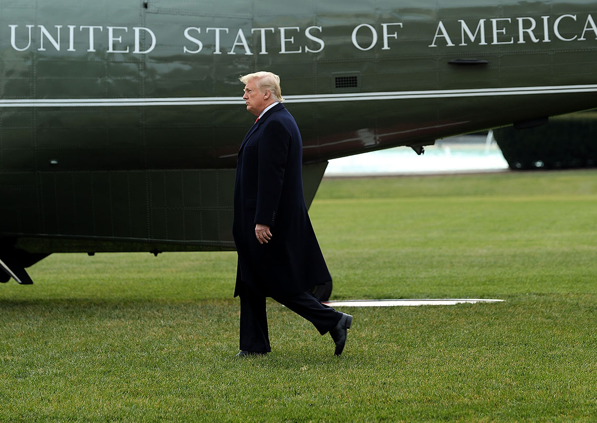 Donald Trump walks across the South Lawn before boarding Marine One and leaving the White House December 22, 2017 in Washington, DC.
