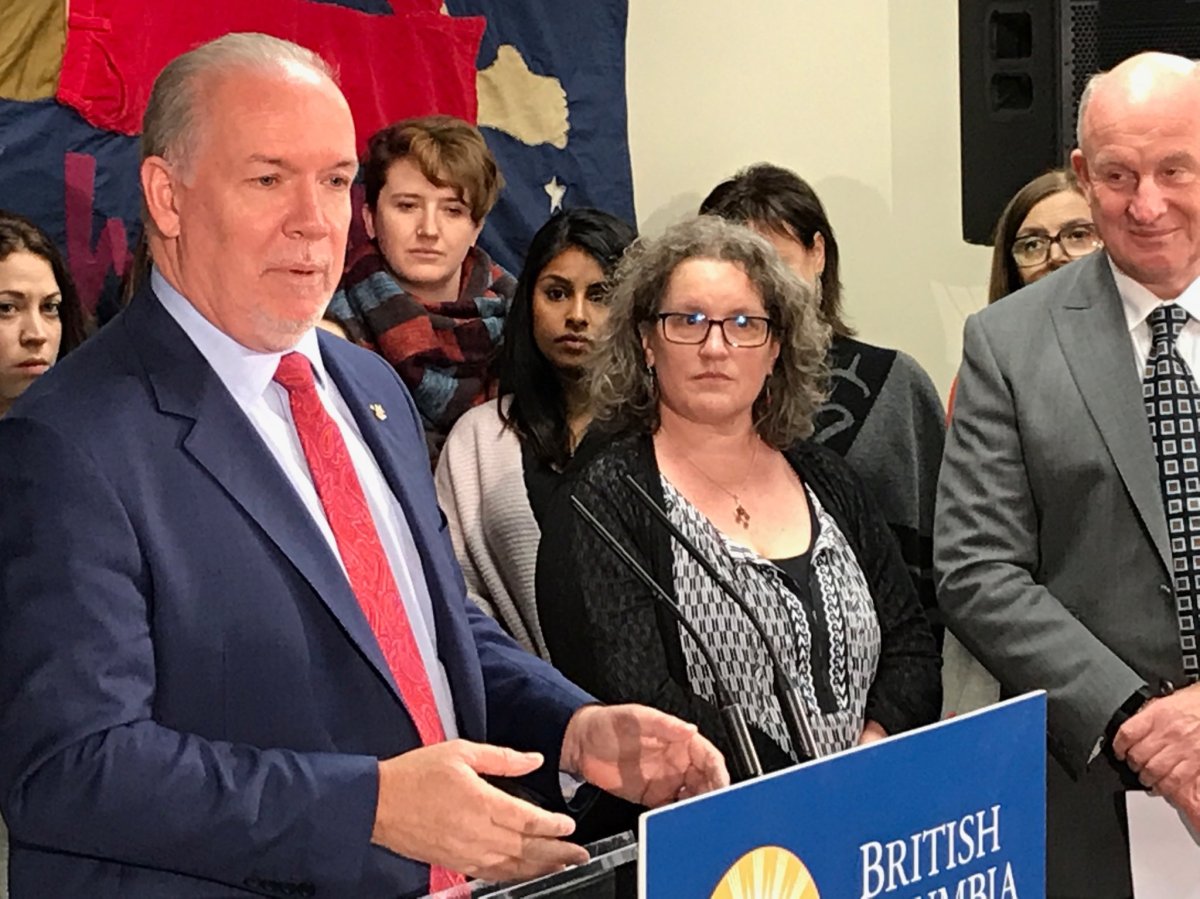 Premier John Horgan (left) announces the government is offering $5 million in one-time funding to help women and children fleeing domestic violence.