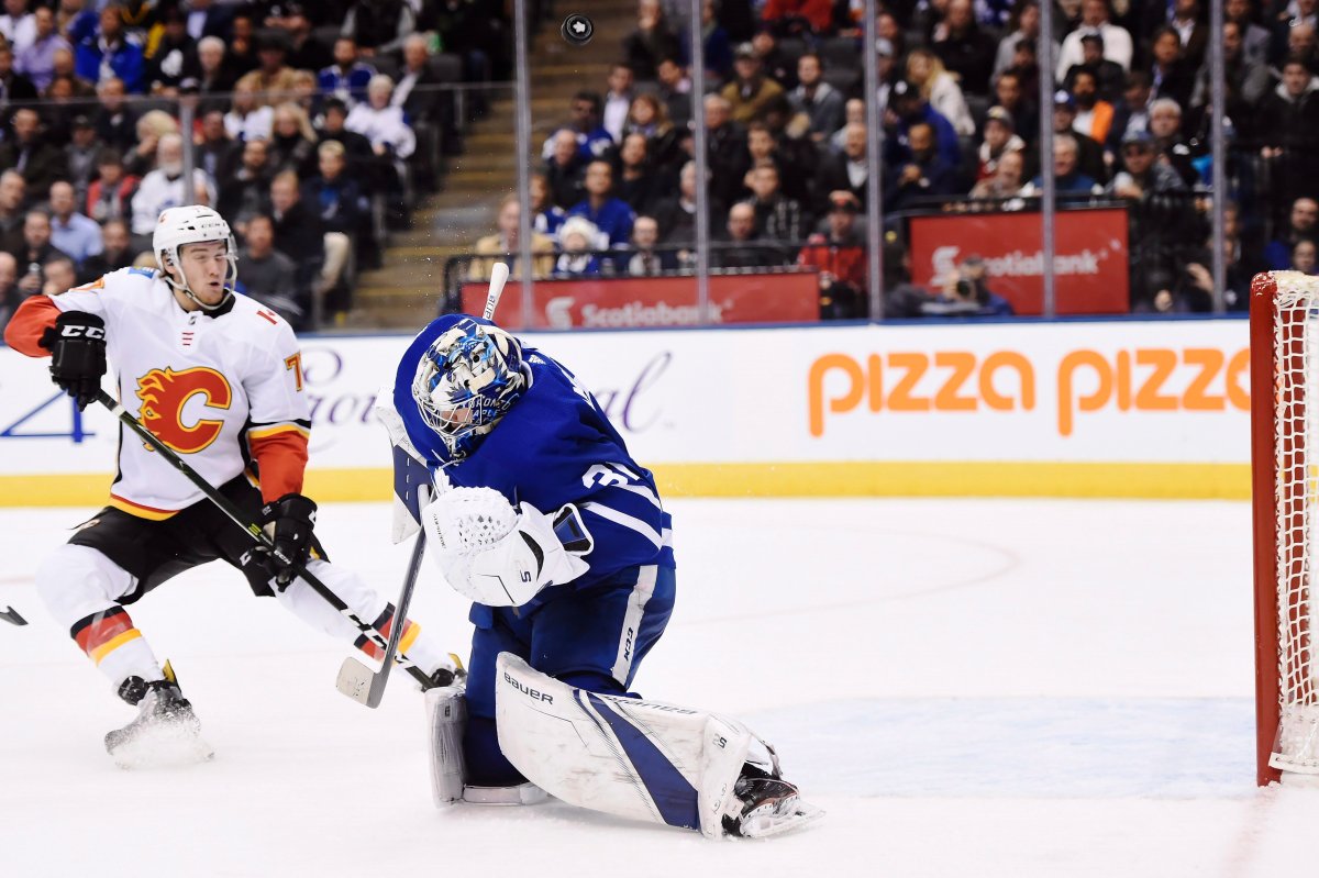Toronto Maple Leafs goalie Frederik Andersen (31) makes a save as Calgary Flames centre Mark Jankowski (77) looks on during third period NHL hockey action in Toronto on Wednesday, December 6, 2017. 