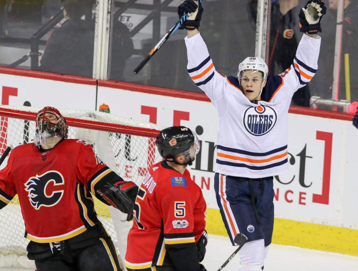 Calgary Flames goalie Mike Smith looks up as Flames' Mark Giordano skates by and Edmonton Oilers' Jesse Puljujarvi celebrates his goal during first period NHL hockey action in Calgary, Saturday, Dec. 2, 2017.THE CANADIAN PRESS/Mike Drew.