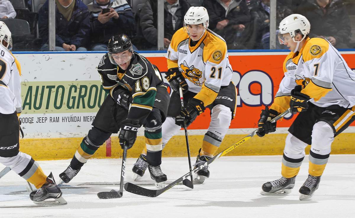 Liam Foudy of the London Knights battles for a puck against Adam Ruzicka of the Sarnia Sting during an OHL game at Budweiser Gardens on Dec. 30, 2017.