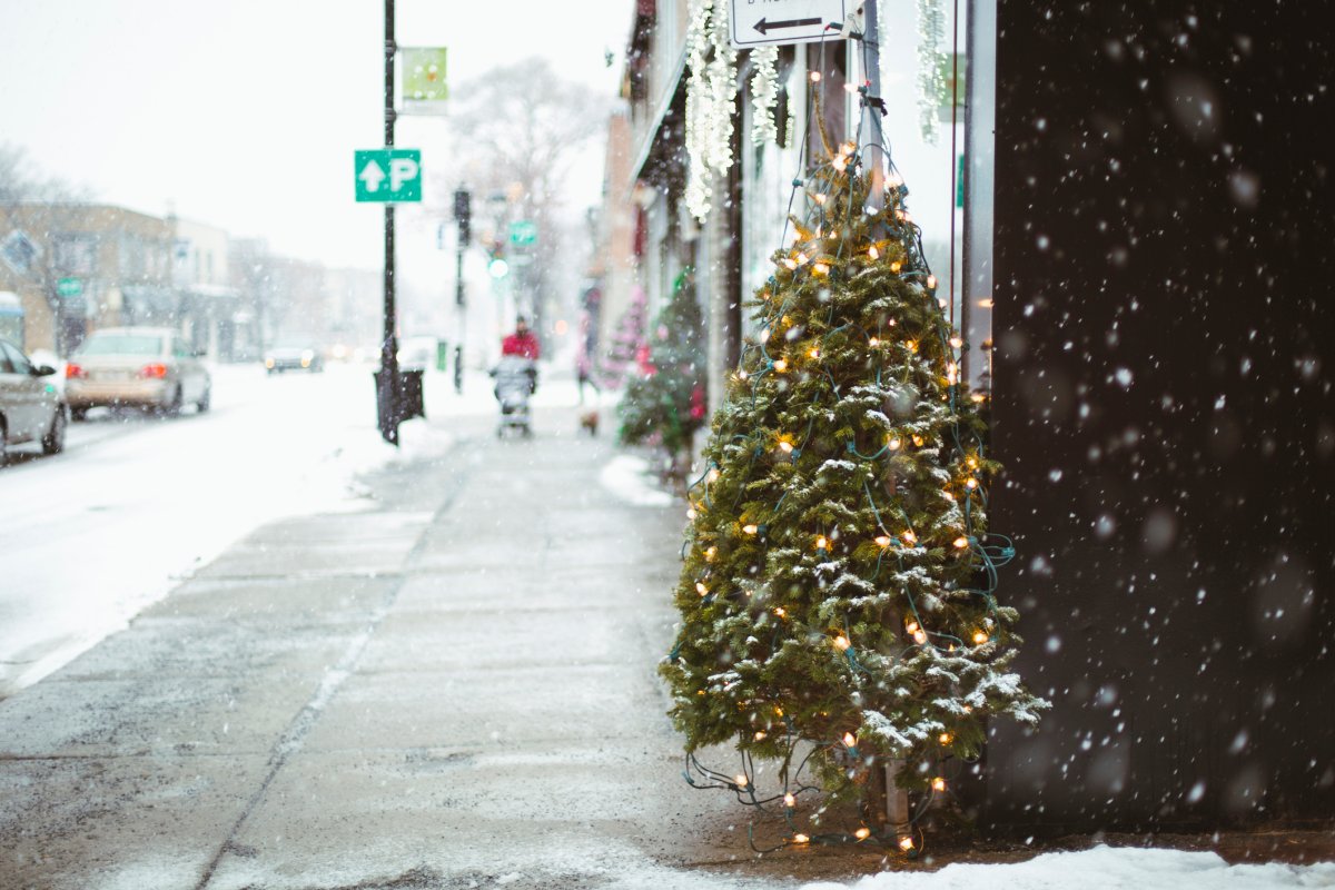 Snow falling on street of Montreal during Christmas time.