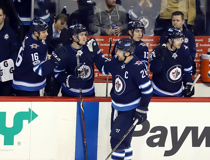 Blake Wheeler of the Winnipeg Jets celebrates his second period goal against the Ottawa Senators with teammates at Bell MTS Place on Dec. 3 in Winnipeg.