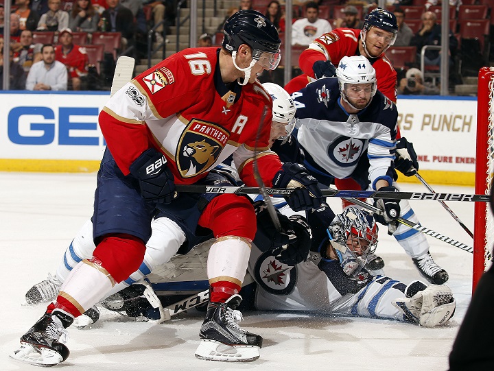 Goaltender Eric Comrie of the Winnipeg Jets defends the net against Aleksander Barkov of the Florida Panthers at the BB&T Center on Dec. 7 in Sunrise, Florida.