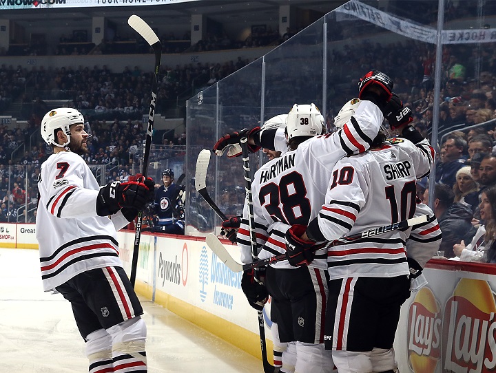 Brent Seabrook of the Chicago Blackhawks joins teammates to celebrate a first period goal against the Winnipeg Jets at Bell MTS Place on Dec. 14.