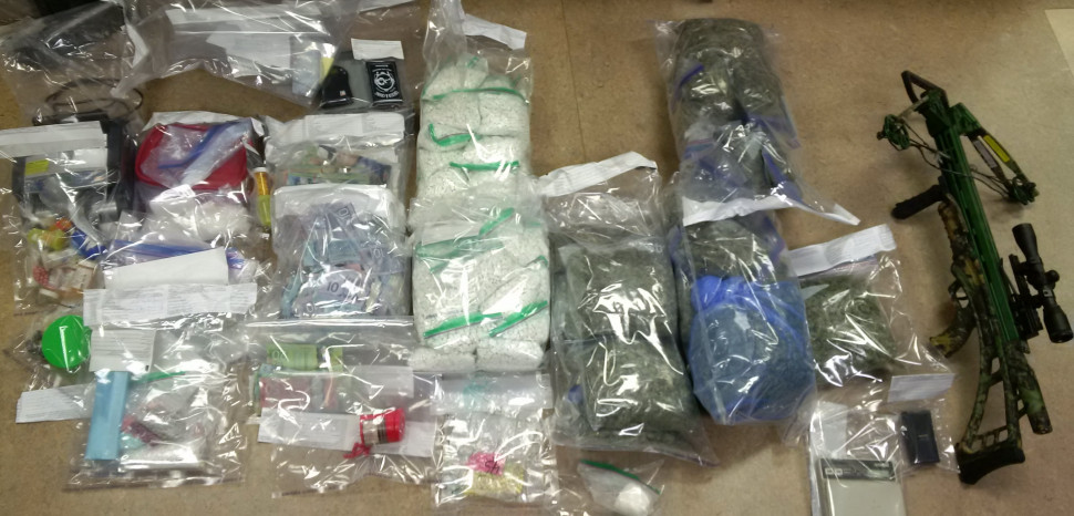 An assortment of drugs and weapons seized by the RCMP .